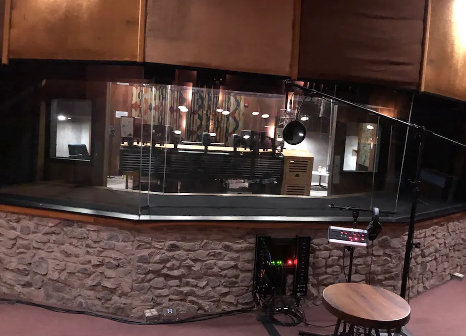 Recording equipment seen through the glass of Studio A at Mercer Music at Capricorn, photographed in 2020.