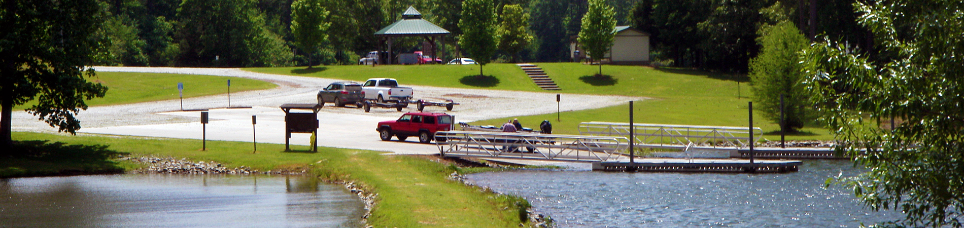 Big Lazer Creek lake, accessible fishing dock, boat ramp, parking and pavilion.