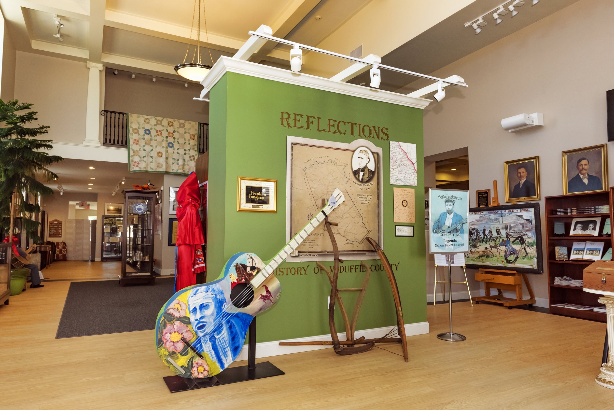 Local-history displays and a painted guitar inside McDuffie Museum in Thomson.