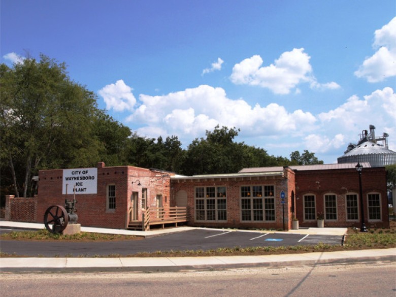 Restored brick Waynesboro Ice Plant with its historic industrial equipment visible outside.