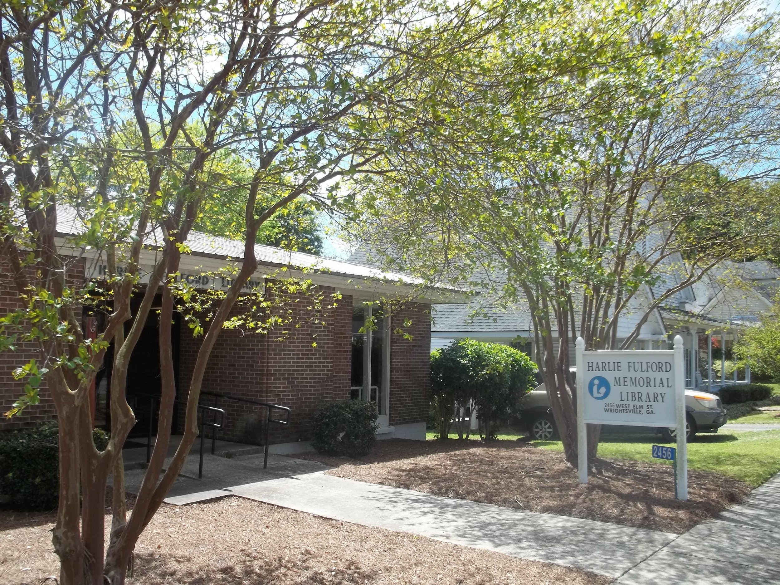 Johnson County Library's brick building and Harlie Fulford Memorial Library sign in Wrightsville.