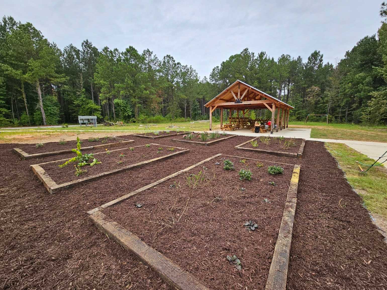 Picnic pavilion and landscaped beds at Ogeechee Crossing Park near Louisville.