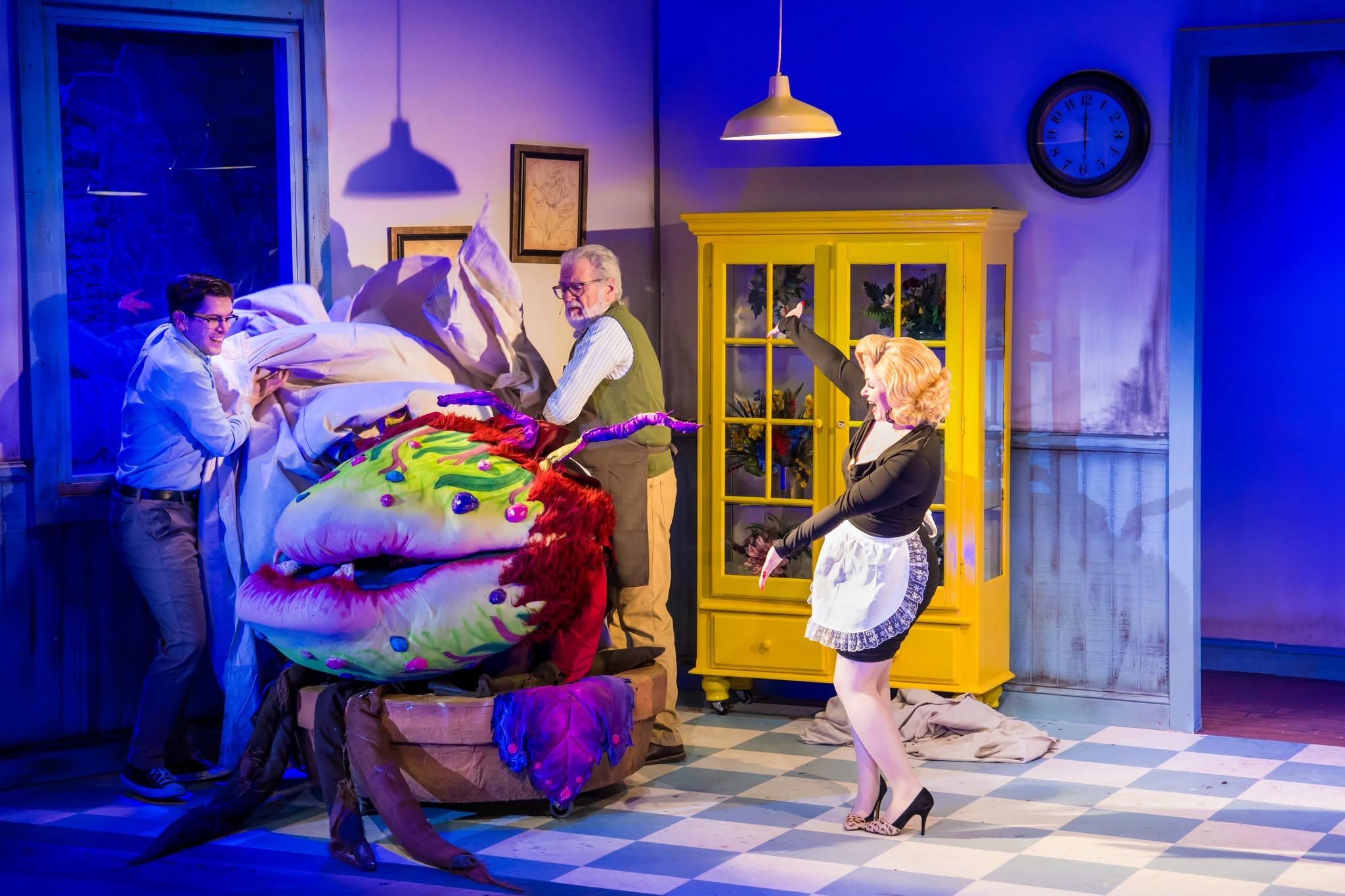 Actors and a large plant puppet in a past Perry Players production of Little Shop of Horrors.