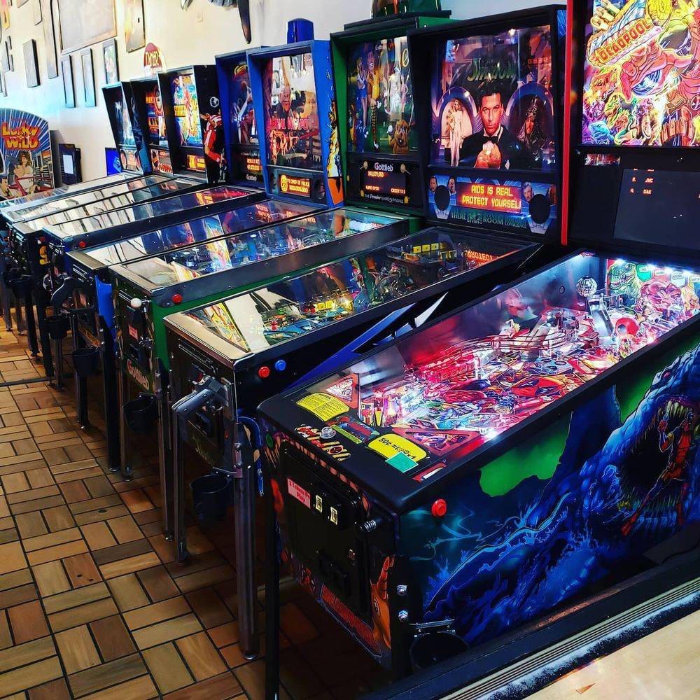 A row of pinball machines inside Reboot Retrocade and Bar.