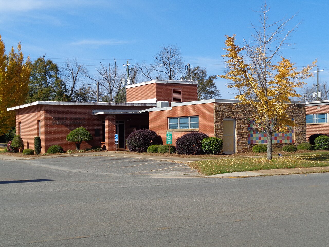 The low brick Schley County Public Library building with facade lettering and accessible parking.