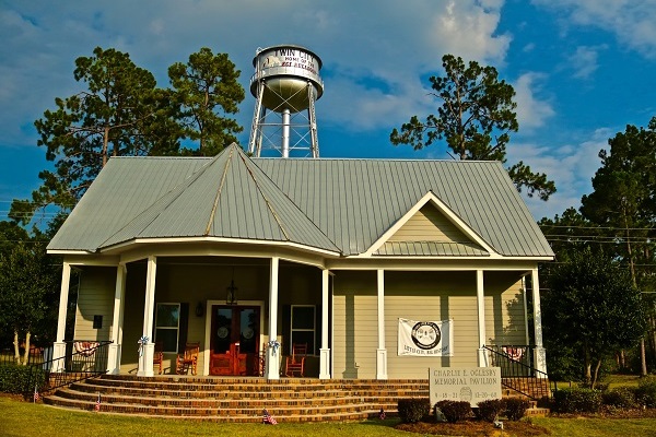 The Charlie Oglesby Memorial Welcome Center, its porch and Twin City water tower.