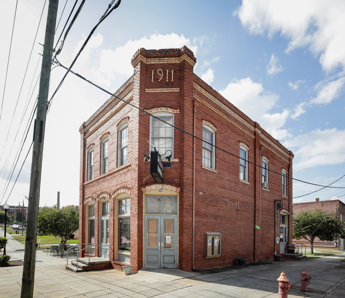 The two-story brick Allen's Market exterior with 1911 displayed above the corner entrance.