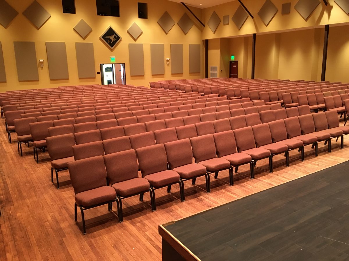 Rows of audience seating inside Festival Hall viewed from the edge of the stage.