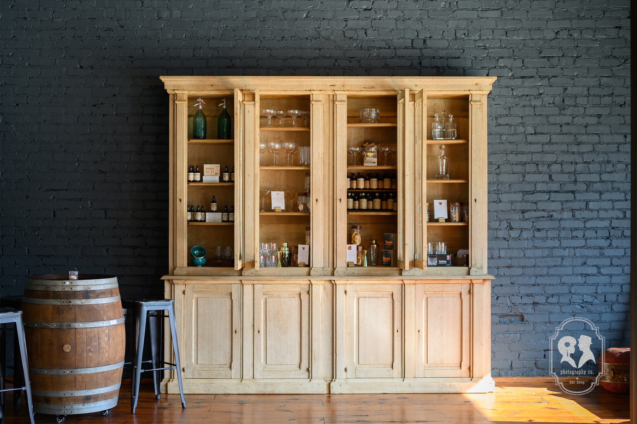 Glassware and cocktail ingredients displayed inside Barrel 118's Mixology Market.