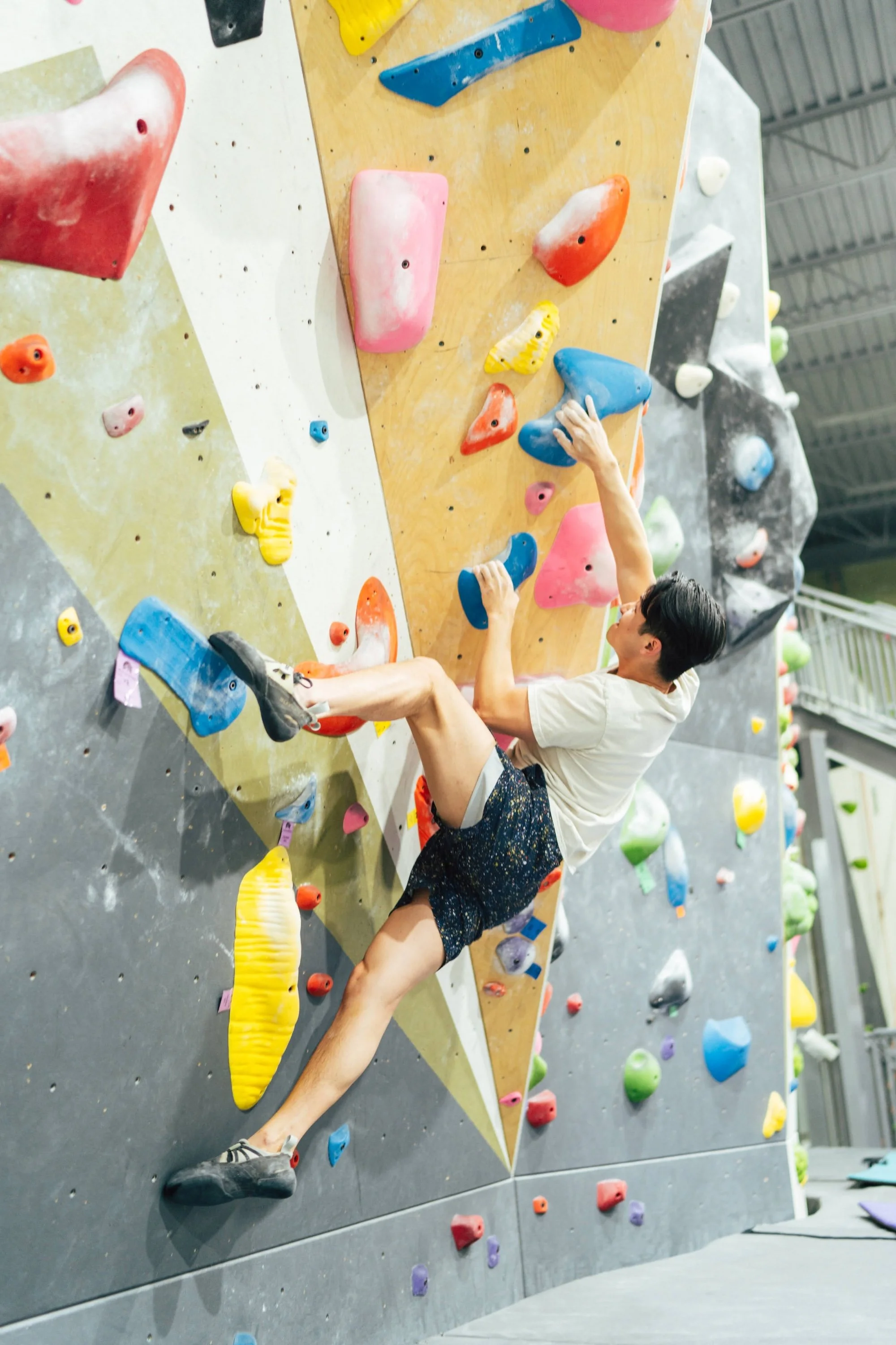 A climber on the distinctive indoor bouldering wall at Macon Rocks.