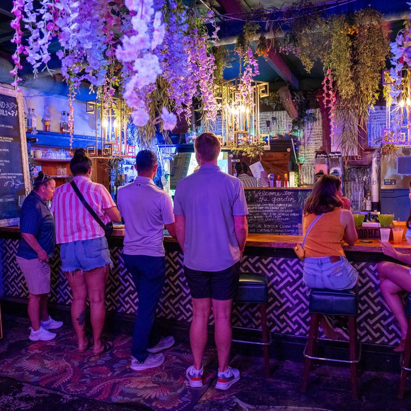 Patrons at the flower-hung bar inside Society Garden in Macon.