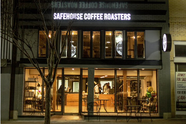 The illuminated Safehouse Coffee Roasters storefront at 109 South Hill Street in downtown Griffin.