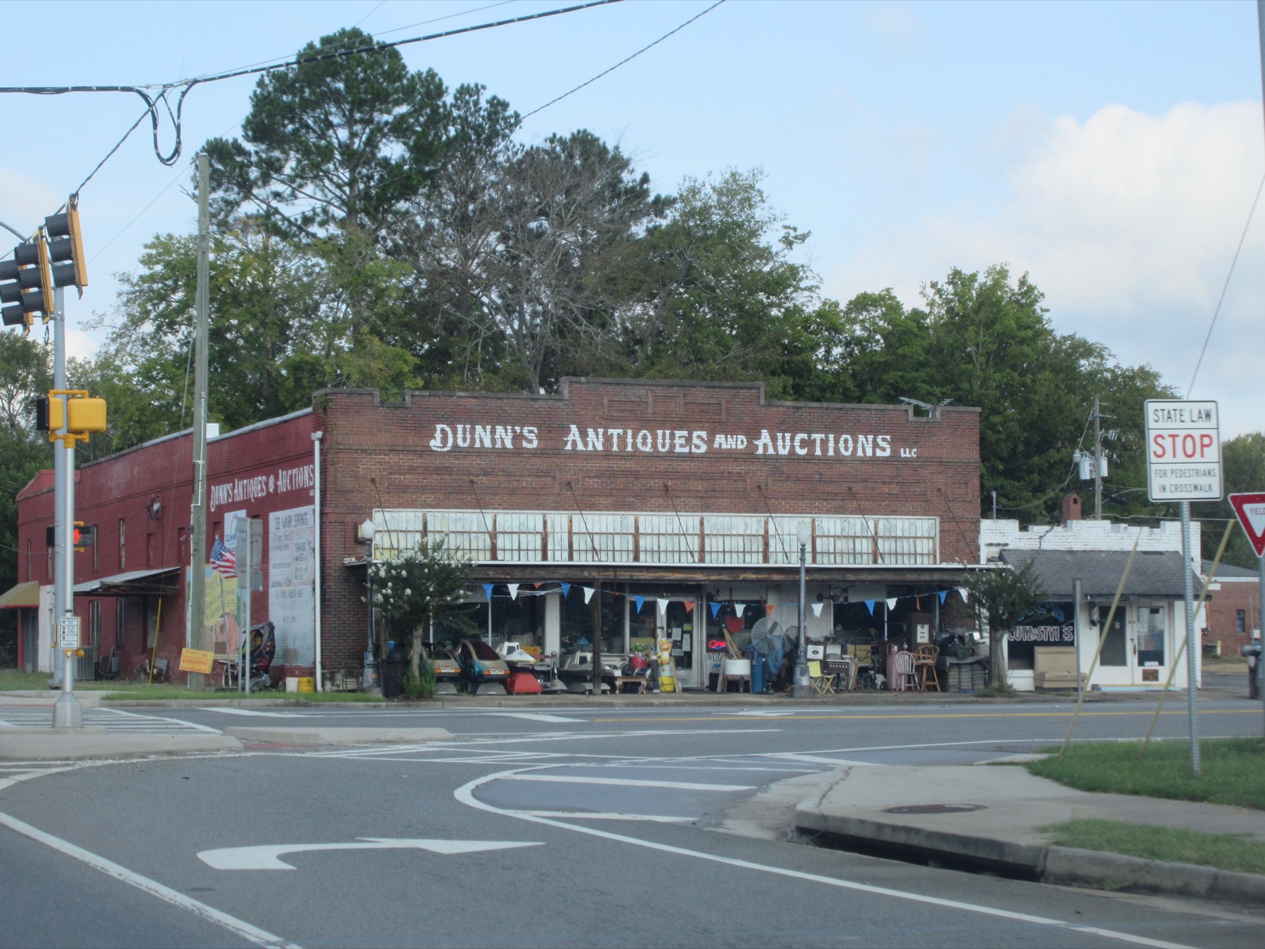 The brick Dunn’s Antiques and Auctions storefront at a downtown Reynolds intersection.