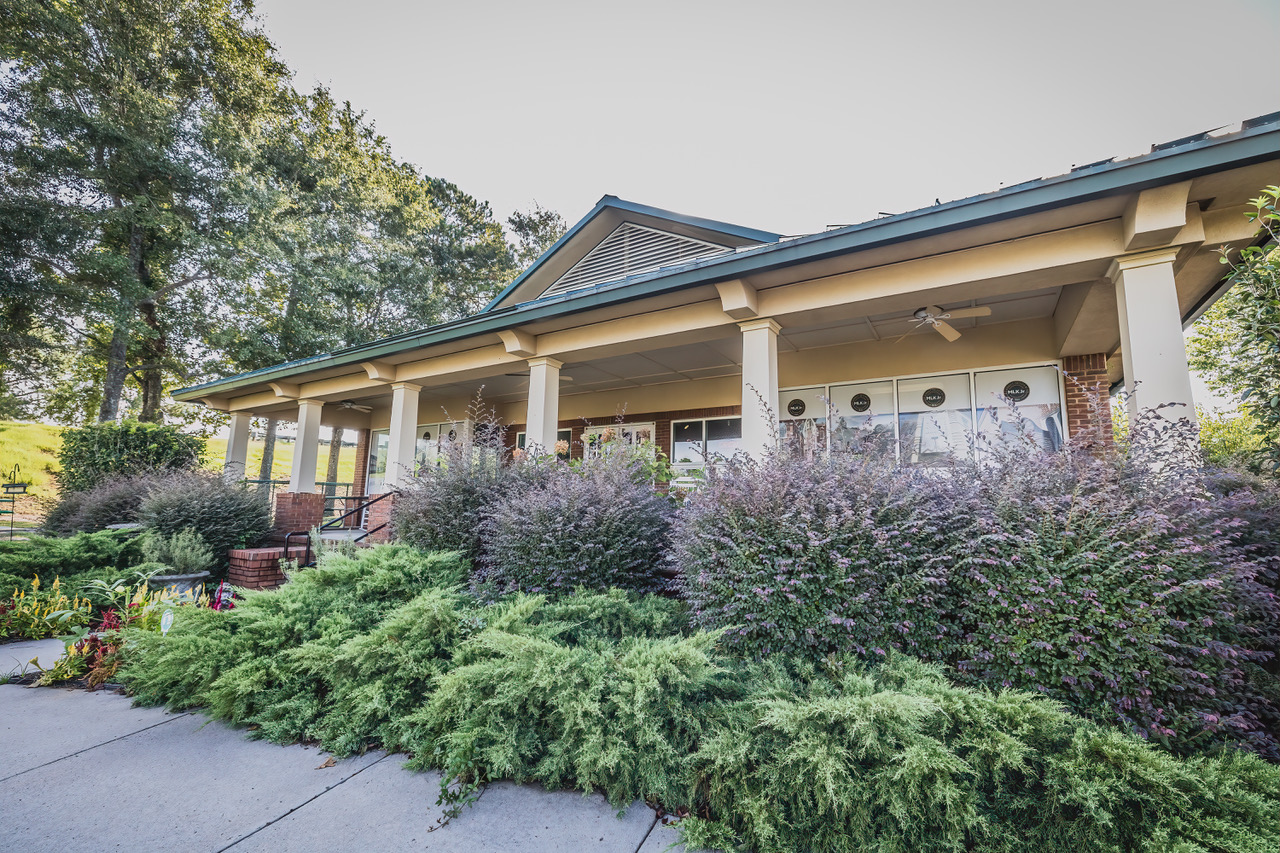 The landscaped front porch and entrance of the Dublin Visitors Center beside its travel-center grounds.