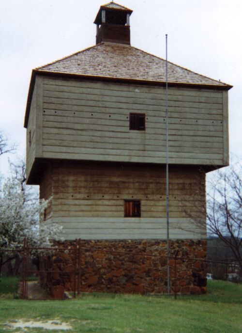 The reconstructed wooden Fort Hawkins blockhouse on its stone foundation in Macon.