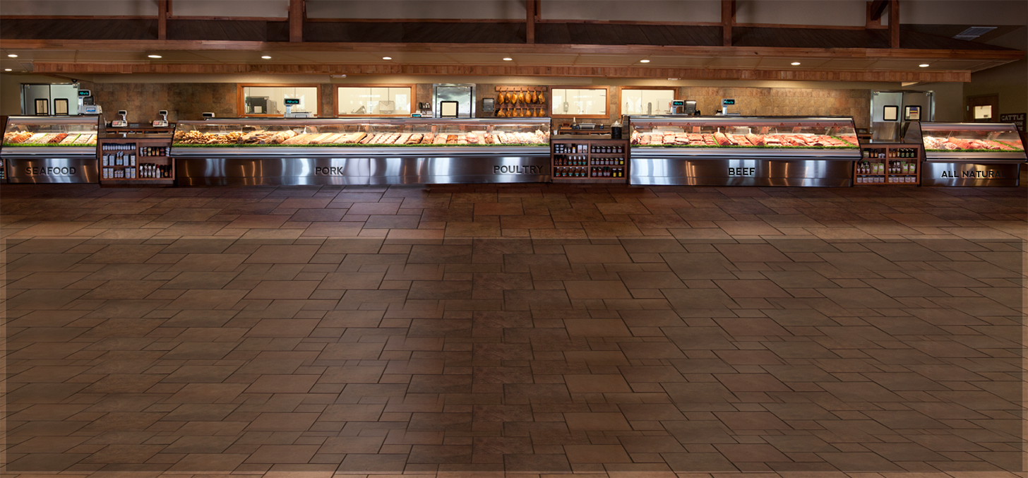 The butcher counter and refrigerated product cases inside M&T Meats in Hawkinsville.
