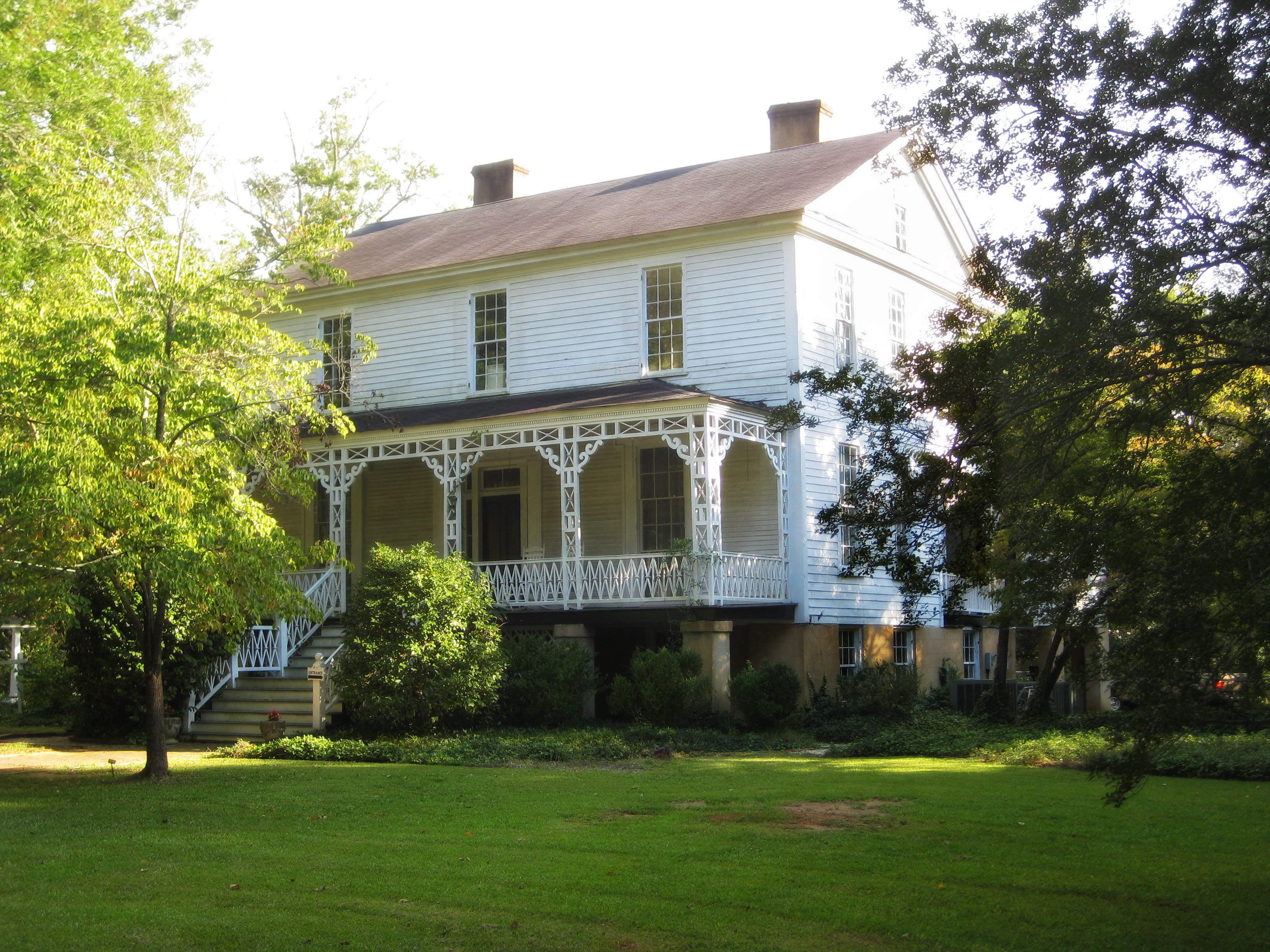 The white Washington Historical Museum house with its decorative front porch.