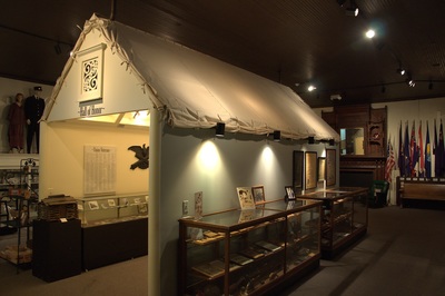 The reconstructed Shacktown tent, display cases and state flags inside Fitzgerald's Blue & Gray Museum.