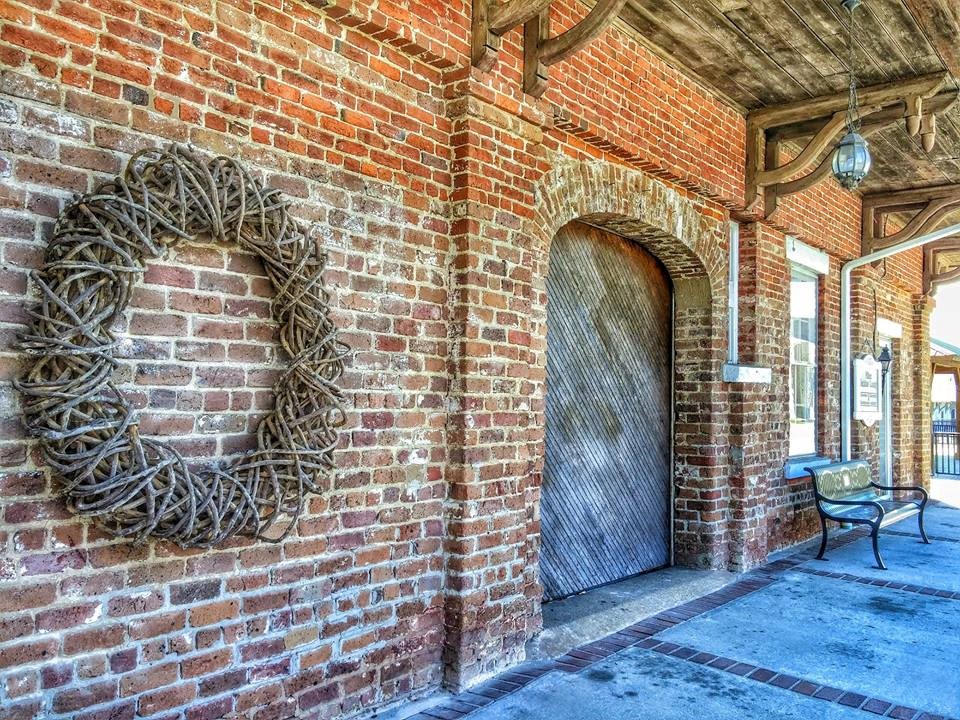 Historic brickwork, a freight door and a covered porch at Millen's museum depot.