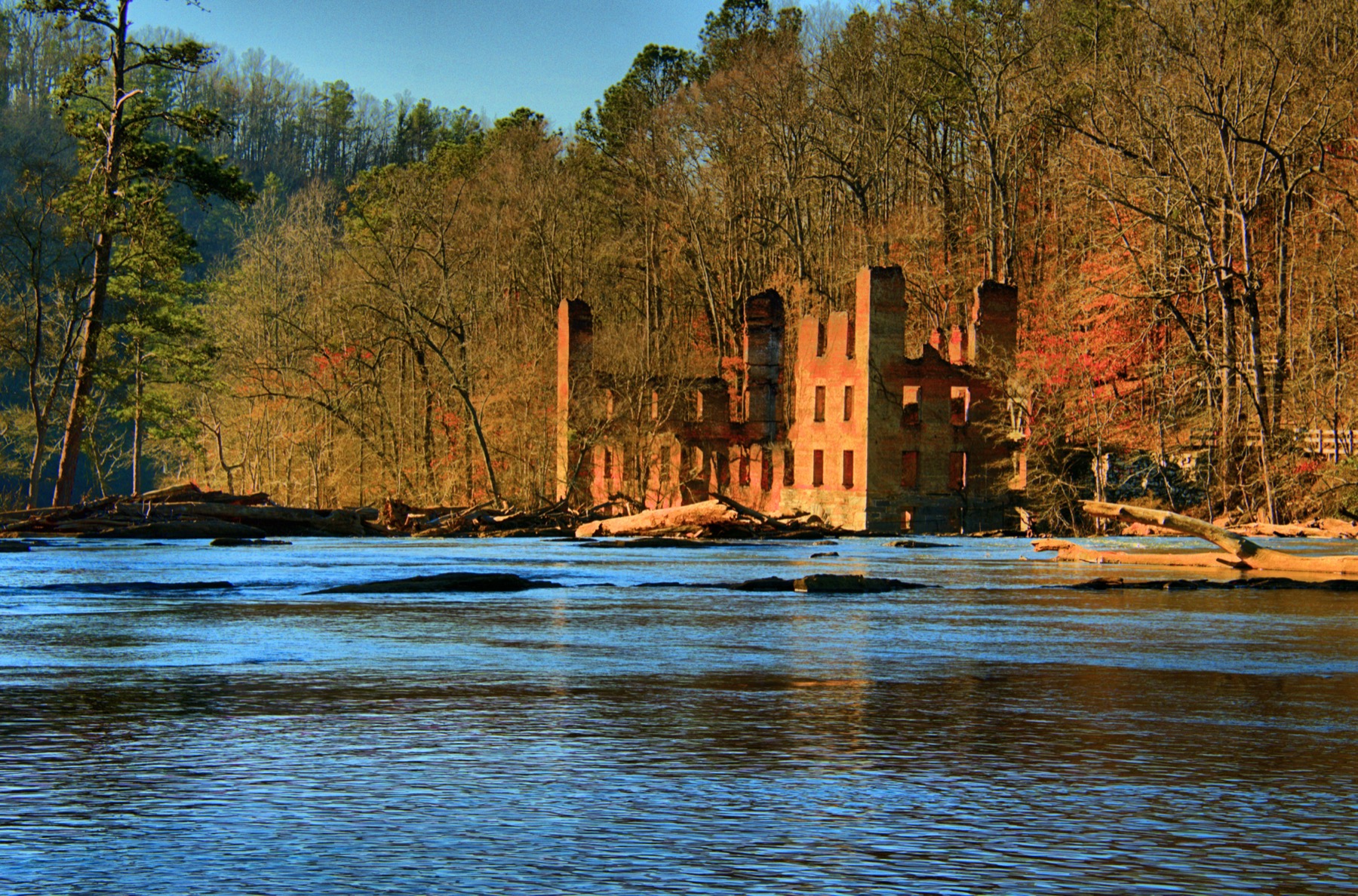 The roofless stone New Manchester textile-mill ruins across Sweetwater Creek.