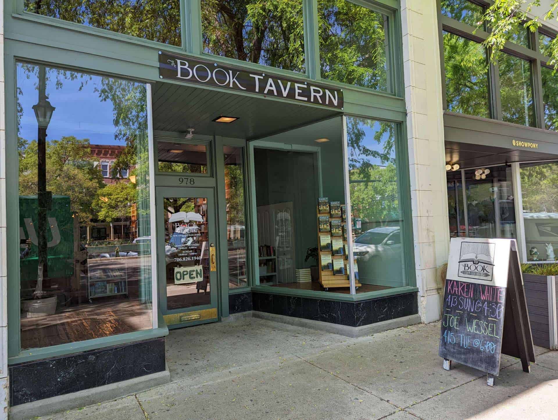 The Book Tavern's green storefront and glass entrance marked 978 on Broad Street in Augusta.