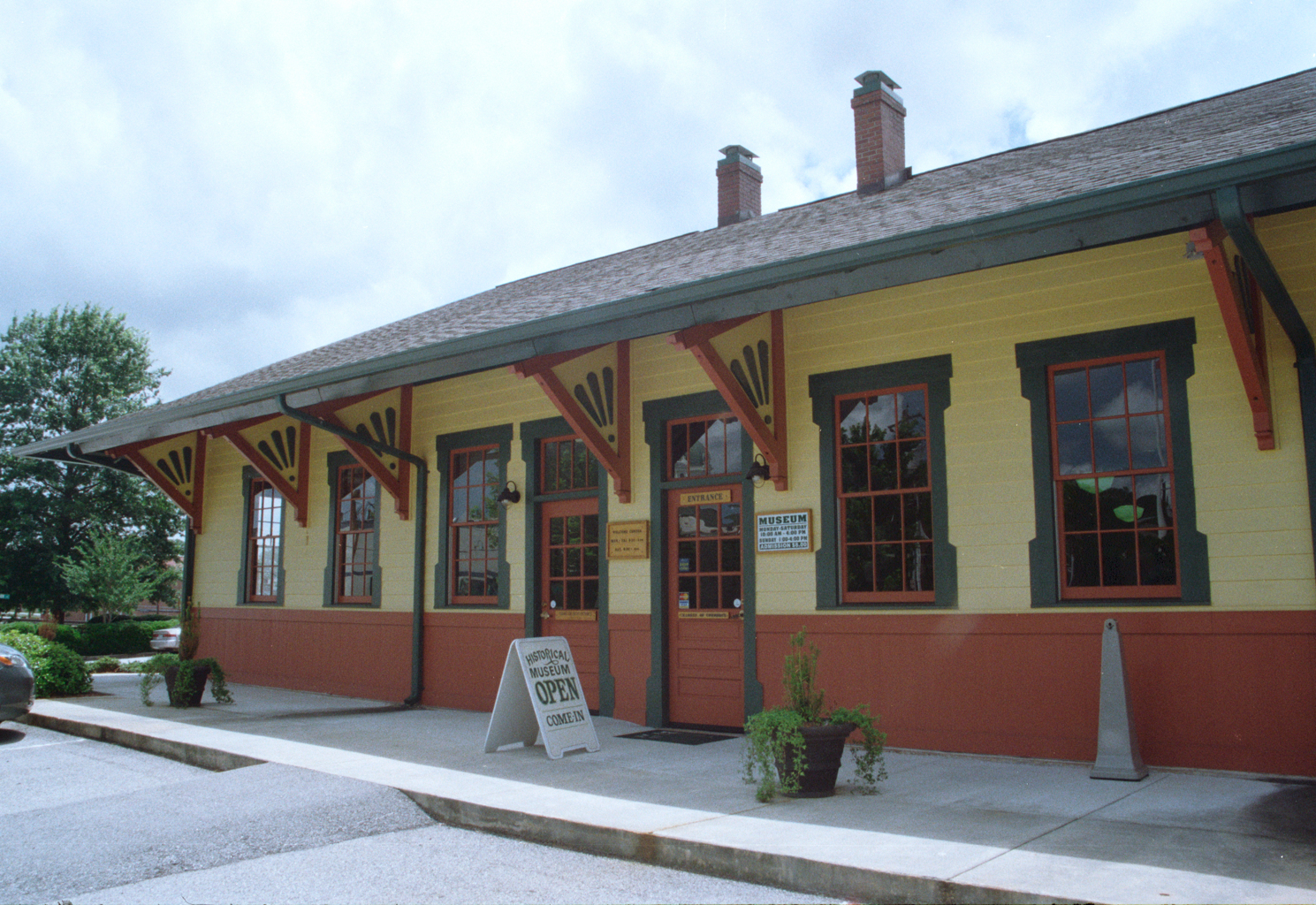 The restored Toccoa railroad depot with Currahee Military Museum signs and its entrance visible.