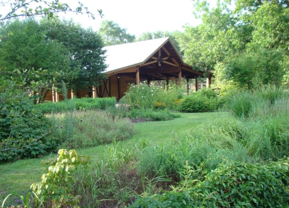 Native garden beds and lawn surrounding the Heritage Pavilion at Georgia Southern's Botanic Garden.