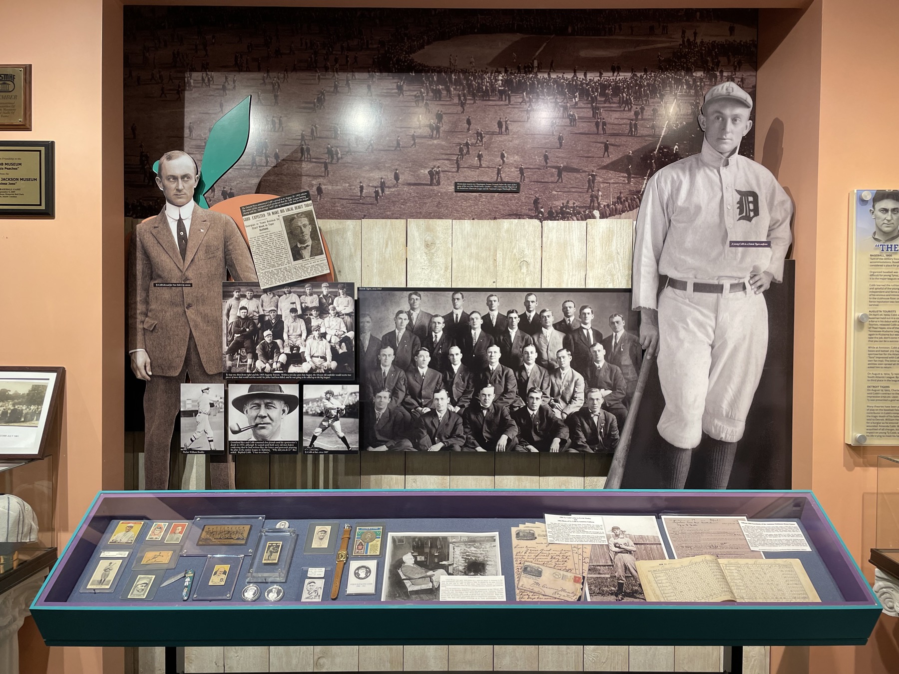 A Ty Cobb Museum exhibit with a career timeline, life-size baseball figures and an artifact case.