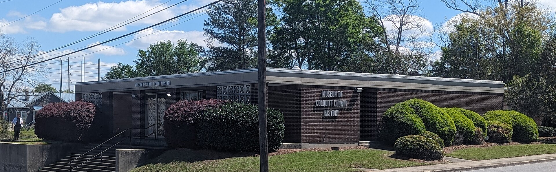 The low brick Museum of Colquitt County History building with its name visible beside the entrance.