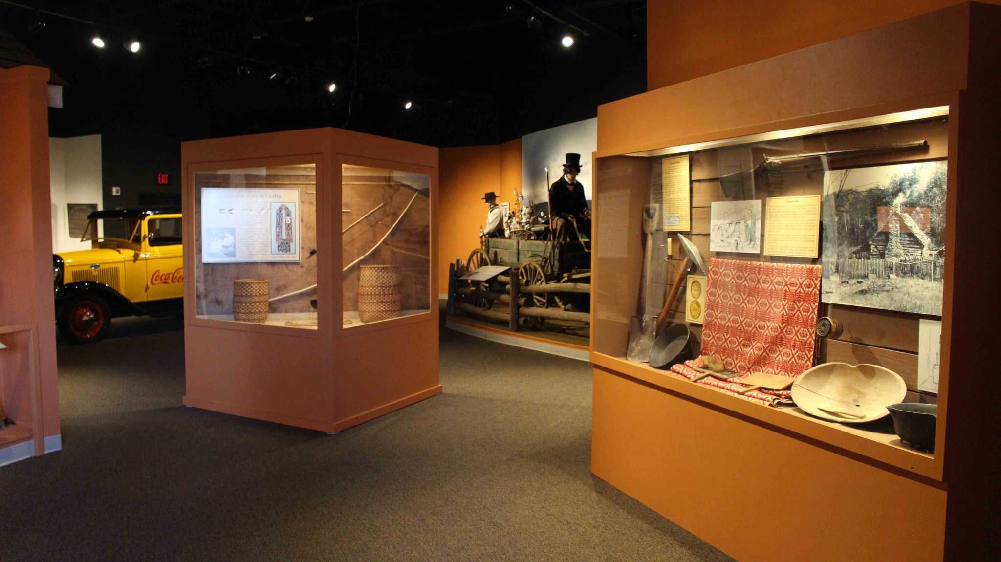 Regional-history exhibits, a vintage delivery truck and artifact cases inside the Northeast Georgia History Center.