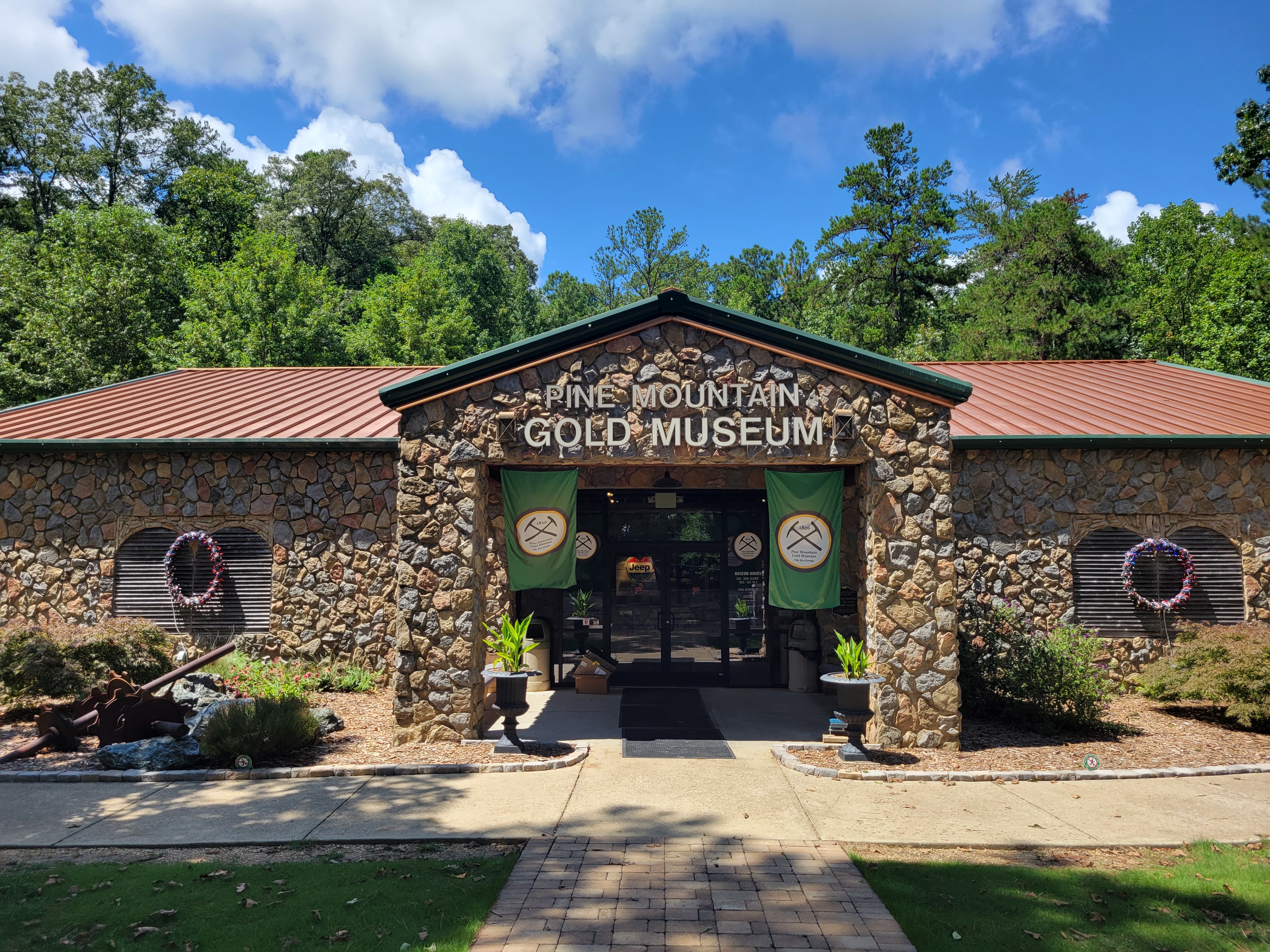 The signed stone entrance of Pine Mountain Gold Museum at Stockmar Park in Villa Rica.