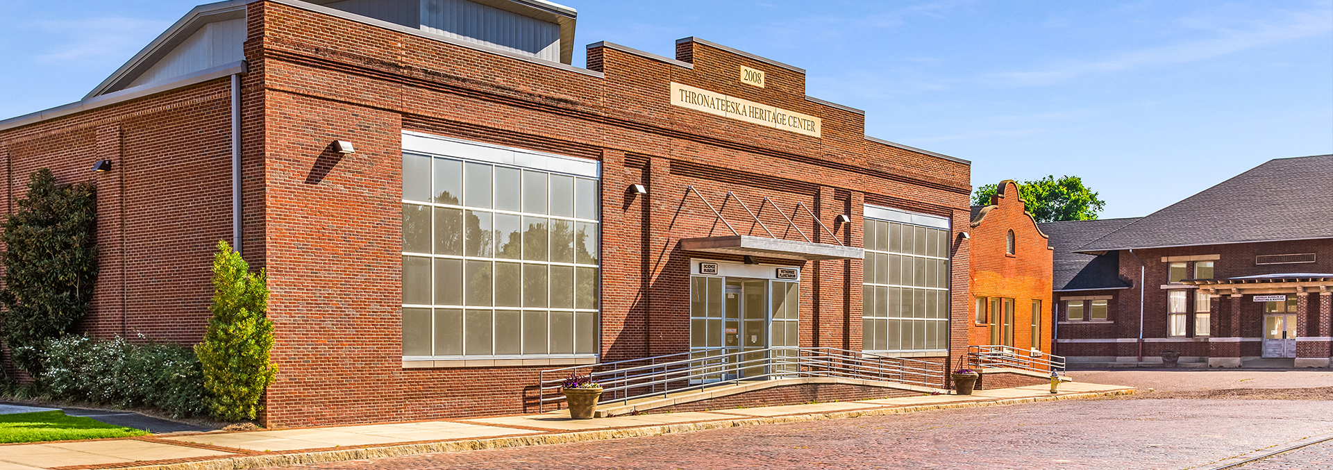 The signed brick Thronateeska Heritage Center and Wetherbee Planetarium buildings beside Albany’s historic rail district.