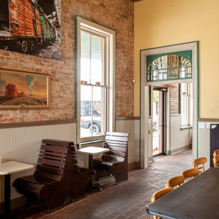 Historic brick-and-wood dining room inside The Railroad Cafe in Fort Valley.