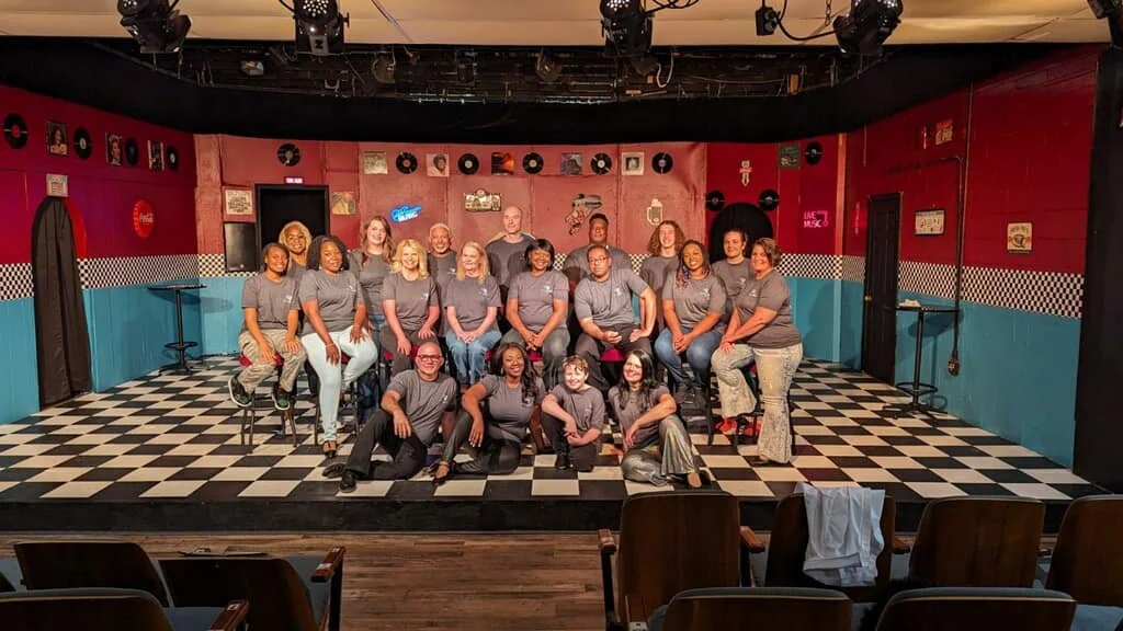 A Warner Robins Little Theatre cast photographed on the theatre's intimate stage.