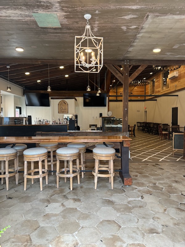 The rustic wood-beamed interior and coffee counter at The Mule Barn in Cochran.
