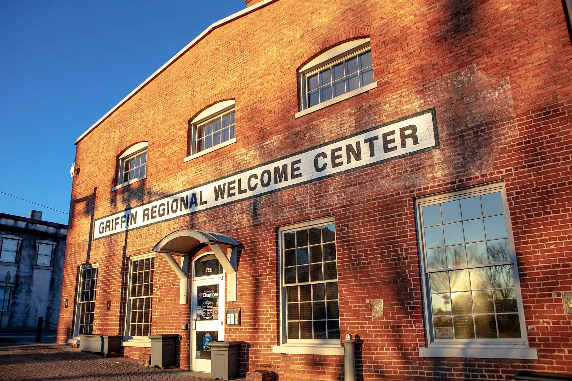 Brick exterior of the Griffin Regional Welcome Center with its painted name above the entrance