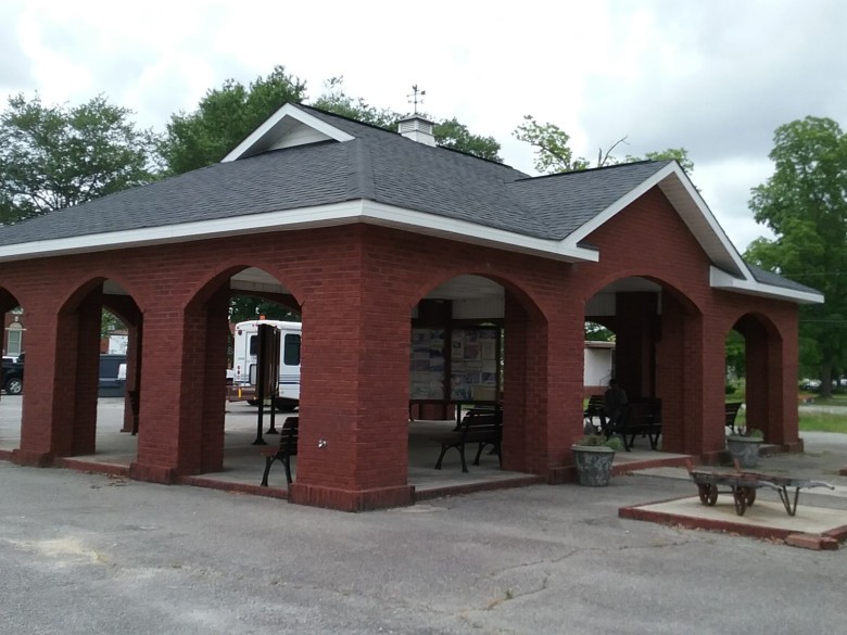 Brick pavilion and agricultural equipment at Cochran-Bleckley Cotton & Peanut Museum