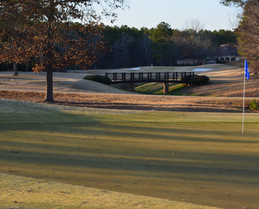 Putting green, flag and footbridge at Southern Hills Golf and Country Club